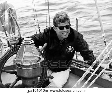 Vintage photo of President John F. Kennedy sailing aboard his yacht. View Large Photo Image Picture - Vintage photo of President John F. Kennedy sailing aboard his yacht.. Fotosearch