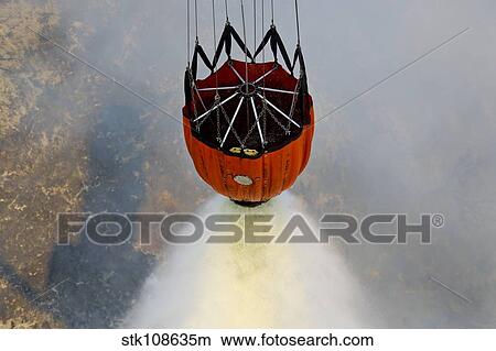 Picture - Water drops are performed using Bambi Buckets to assist the wildfires in California.. Fotosearch