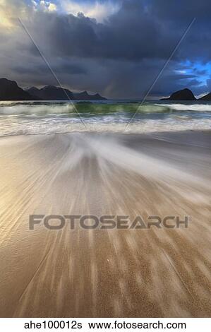 Waves washing back to sea on Haukland Beach, Lofoten, Norway. View Large Photo Image Stock Photograph - Waves washing back to sea on Haukland Beach, Lofoten, Norway.. Fotosearch