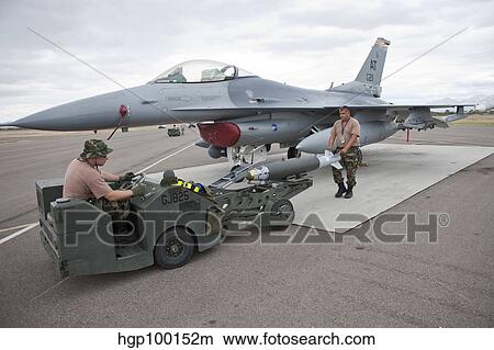 Weapons loaders prepare to load a GBU-38 JDAM on an F-16. View Large Photo Image Picture - Weapons loaders prepare to load a GBU-38 JDAM on an F-16.. Fotosearch