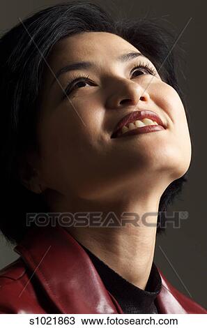 A Beautiful Asian Woman Wearing A Leather Jacket Has Short Hair