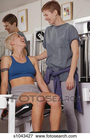 Lesbian Couple Working Out At Gym Stock Photo S1043427
