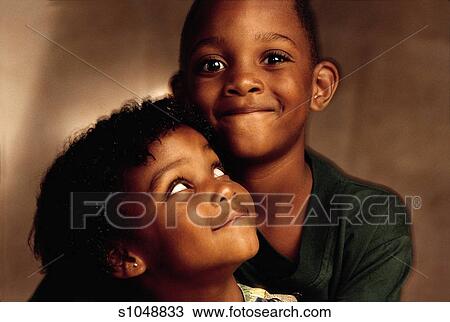 Two Happy Children An African American Boy Who Is Wearing A Green