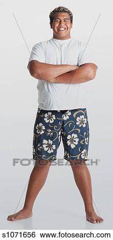 A Young Smiling Hawaiian Man With Bleached Hair Wearing Flowered