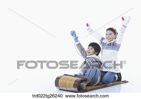 Clipart - boy and girl go sleding. Fotosearch