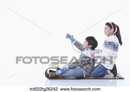 Drawing - boy and girl go sleding. Fotosearch