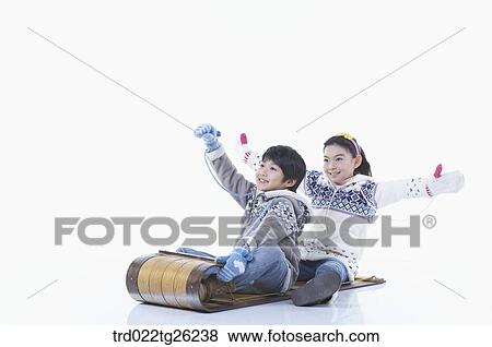 Stock Illustration - boy and girl go sleding. Fotosearch
