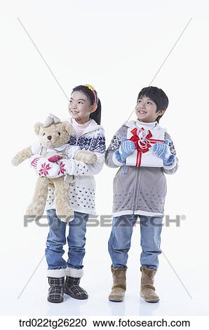 Clipart - boy and girl got christmas present. Fotosearch