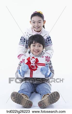 Drawing - boy and girl got christmas present. Fotosearch