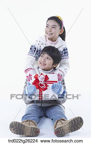 Stock Illustration - boy and girl got christmas present. Fotosearch