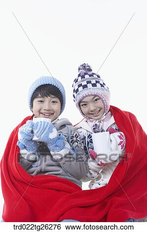 Stock Illustration - boy and girl holding the mugs in the red blanket. Fotosearch