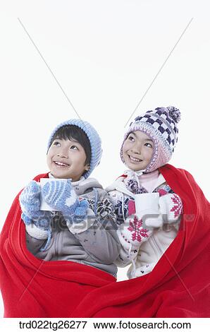 boy and girl holding the mugs in the red blanket View Large Illustration Stock Illustration - boy and girl holding the mugs in the red blanket. Fotosearch