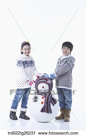 Clip Art - boy and girl with a snowman. Fotosearch