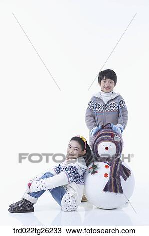 Drawing - boy and girl with a snowman. Fotosearch