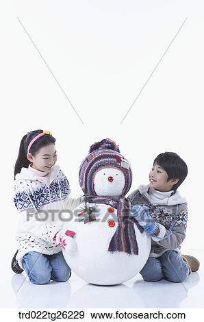 boy and girl with a snowman View Large Illustration Stock Illustration - boy and girl with a snowman. Fotosearch
