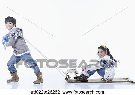 Drawing - boy pulling the sled and girl sitting on. Fotosearch
