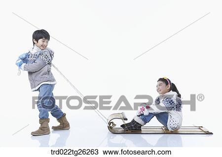 Drawing - boy pulling the sled and girl sitting on. Fotosearch