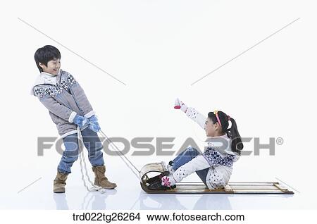 Stock Illustration - boy pulling the sled and girl sitting on. Fotosearch