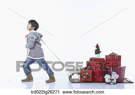 boy pulling the sled that christmas presents were on it View Large Illustration Clip Art - boy pulling the sled that christmas presents were on it. Fotosearch
