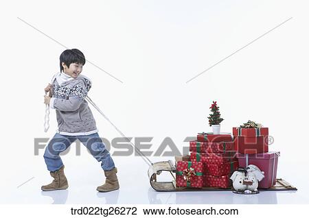 boy pulling the sled that christmas presents were on it View Large Illustration Drawing - boy pulling the sled that christmas presents were on it. Fotosearch