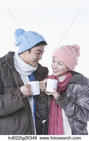 Stock Illustration - couple holding the mugs. Fotosearch