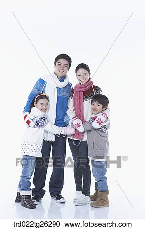 Clipart - family is hugging each other in winter goods. Fotosearch