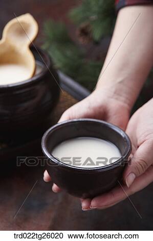 Clipart - holding the bowl of Korean traditional alcohol made from grain. Fotosearch