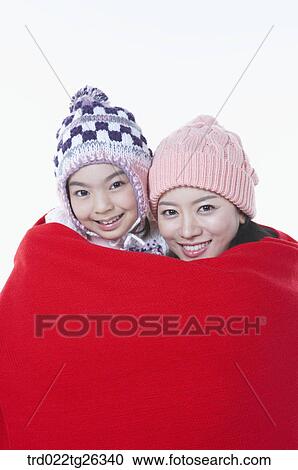 Clipart - mother and daughter is covering with the red blanket. Fotosearch