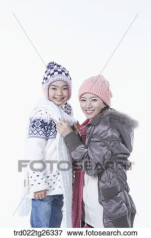Stock Illustration - mother tying daughter's muffler. Fotosearch