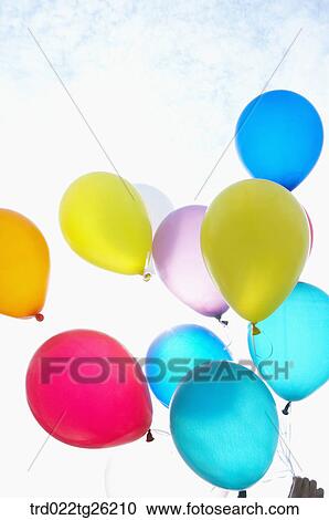Clipart - multi colored balloons flying to the sky. Fotosearch