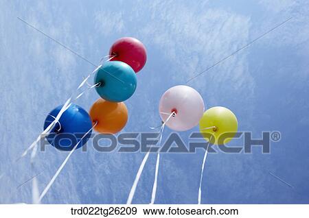 Stock Illustration - multi colored balloons flying to the sky. Fotosearch