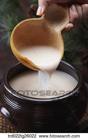 Drawing - pouring Korean traditional alcohol made from grain. Fotosearch