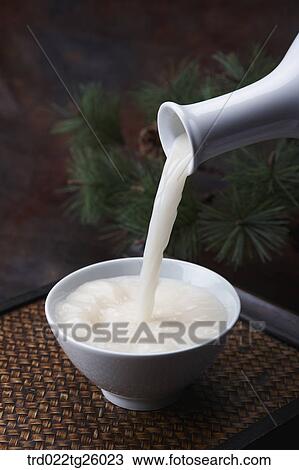 Drawing - pouring Korean traditional alcohol made from grain. Fotosearch
