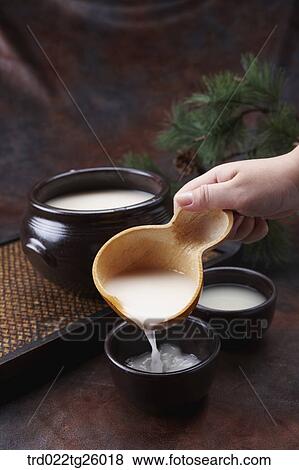 Stock Illustration - pouring Korean traditional alcohol made from grain. Fotosearch