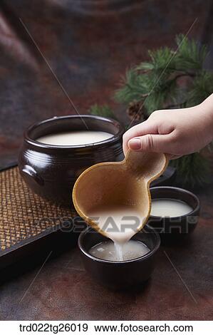 Stock Illustration - pouring Korean traditional alcohol made from grain. Fotosearch