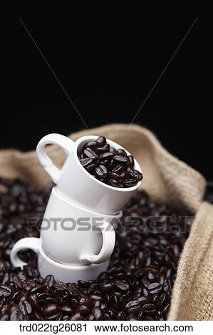 roasted coffee beans and cups in the sack View Large Illustration Clip Art - roasted coffee beans and cups in the sack. Fotosearch