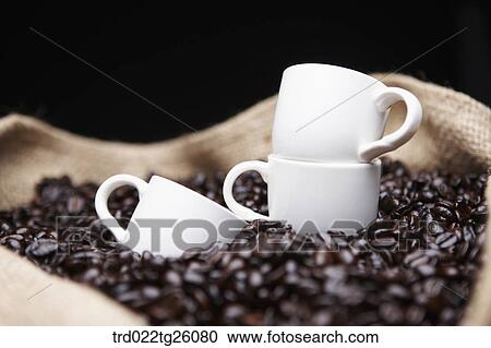 roasted coffee beans and cups in the sack View Large Illustration Clipart - roasted coffee beans and cups in the sack. Fotosearch