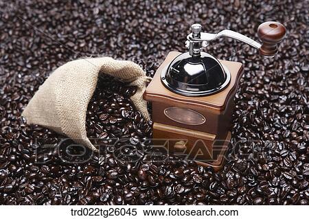 Stock Illustration - roasted coffee beans and grinder. Fotosearch