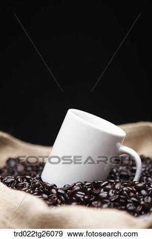 roasted coffee beans and mug in the sack View Large Illustration Stock Illustration - roasted coffee beans and mug in the sack. Fotosearch