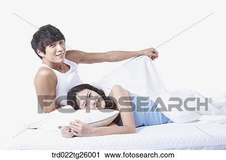 Clip Art - woman and guy relaxed on the bed. Fotosearch