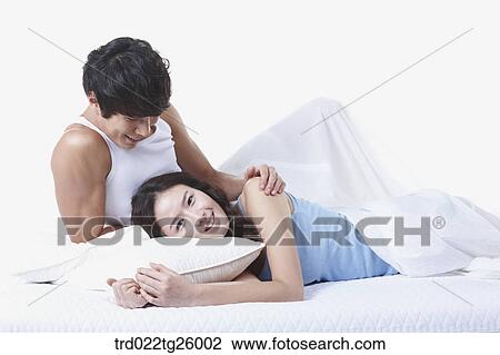 Drawing - woman and guy relaxed on the bed. Fotosearch