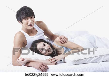 Stock Illustration - woman and guy relaxed on the bed. Fotosearch