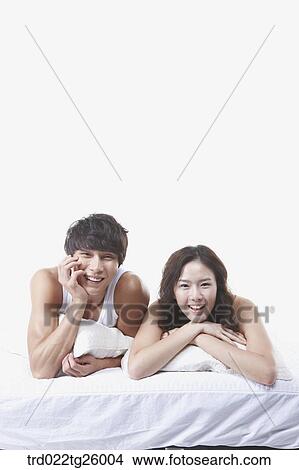 woman and guy relaxed on the bed with smile View Large Illustration Stock Illustration - woman and guy relaxed on the bed with smile. Fotosearch