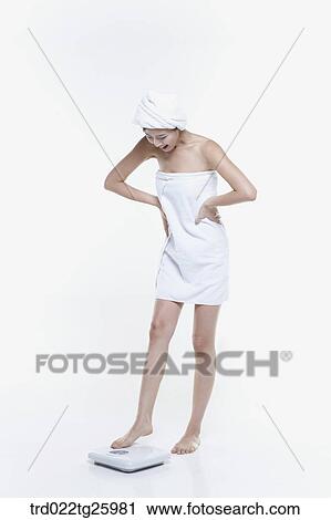 woman in a towel measuring her weight View Large Illustration Clip Art - woman in a towel measuring her weight. Fotosearch