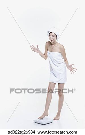 woman in a towel measuring her weight View Large Illustration Stock Illustration - woman in a towel measuring her weight. Fotosearch