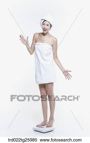 woman in a towel measuring her weight View Large Illustration Stock Illustration - woman in a towel measuring her weight. Fotosearch