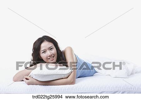 Stock Illustration - woman lay down with a pillow. Fotosearch