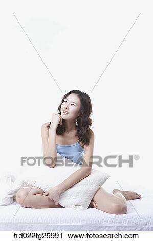 Clip Art - woman sitting on the floor with pillow. Fotosearch