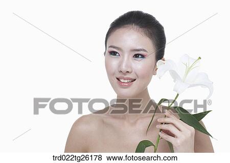 woman wearing makeup and holding blossom View Large Illustration Stock Illustration - woman wearing makeup and holding blossom. Fotosearch