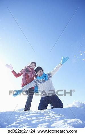 Picture - cordial couple having fun in ski resort with big smile. Fotosearch